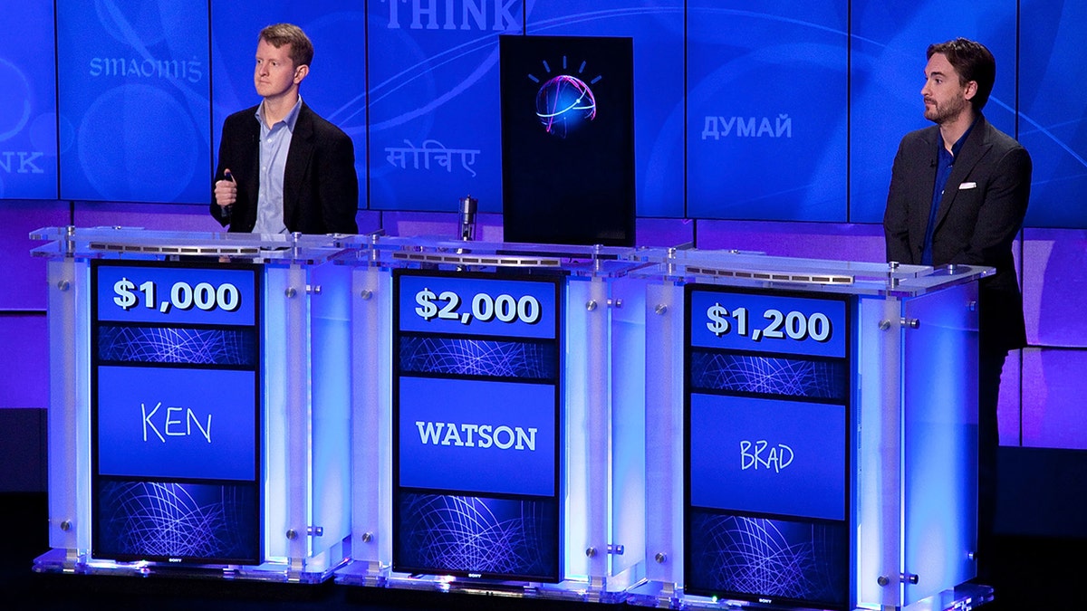 Ken Jennings, Watson IBM, and Brad Rutter on Jeopardy stage
