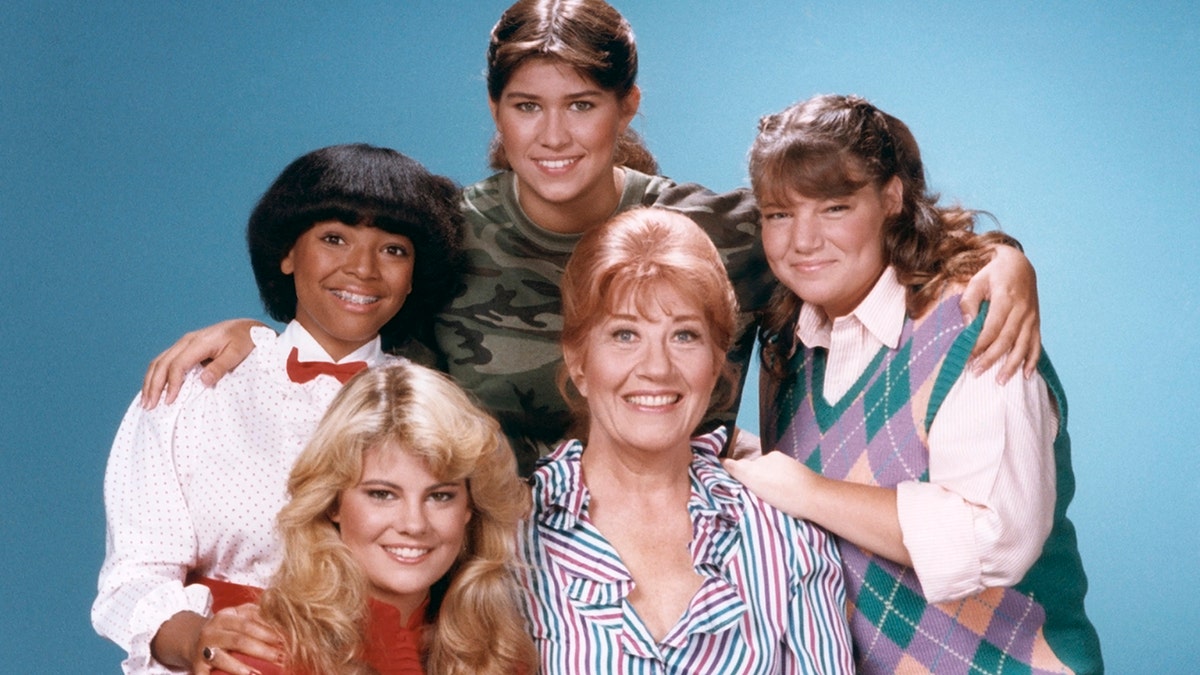 The Facts of Life fact posting together in character and smiling.