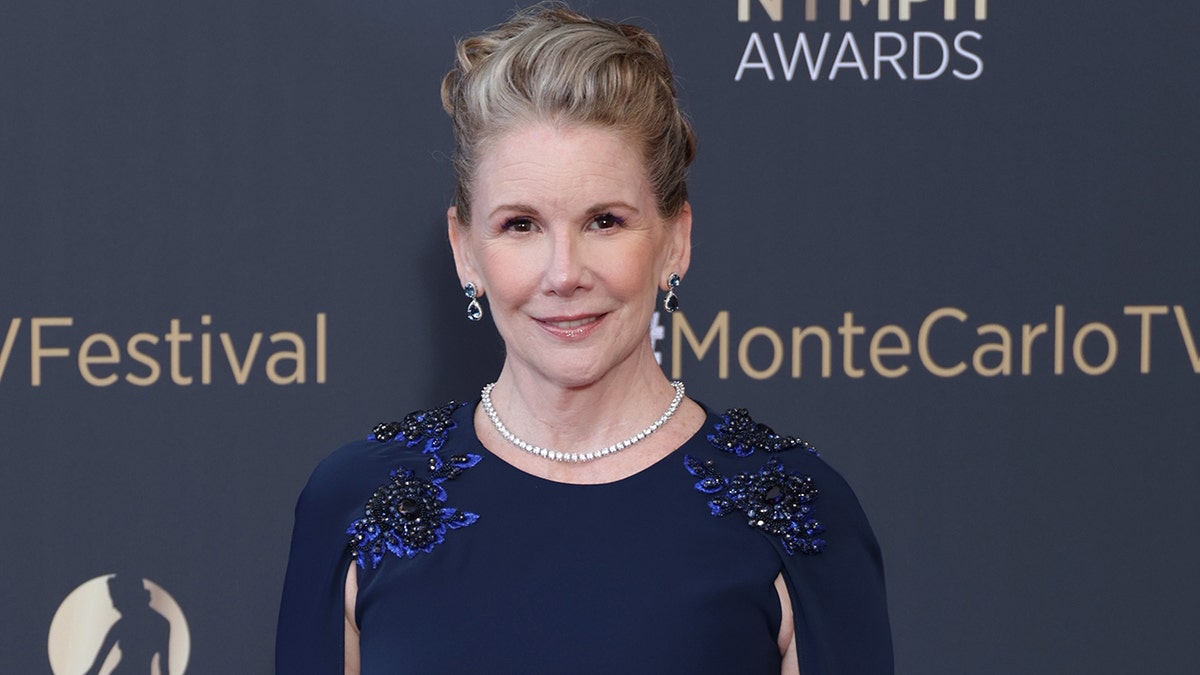 Melissa Gilbert wearing a blue gown on the red carpet.