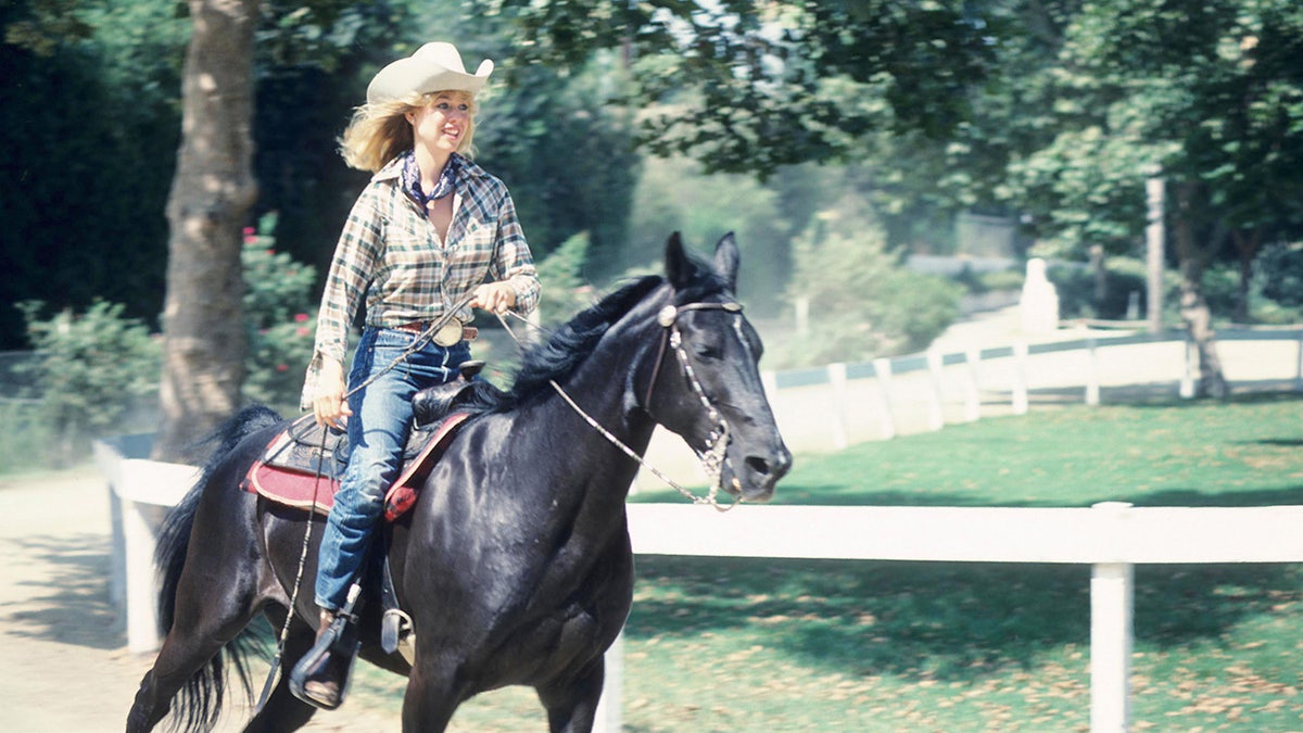 Jenilee Harrison riding a horse.