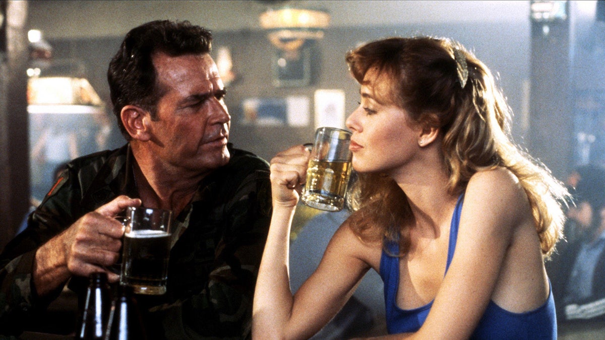 Jenilee Harrison having a beer with an actor at a bar.