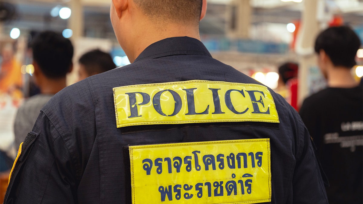 police officer with royal thai police insignia