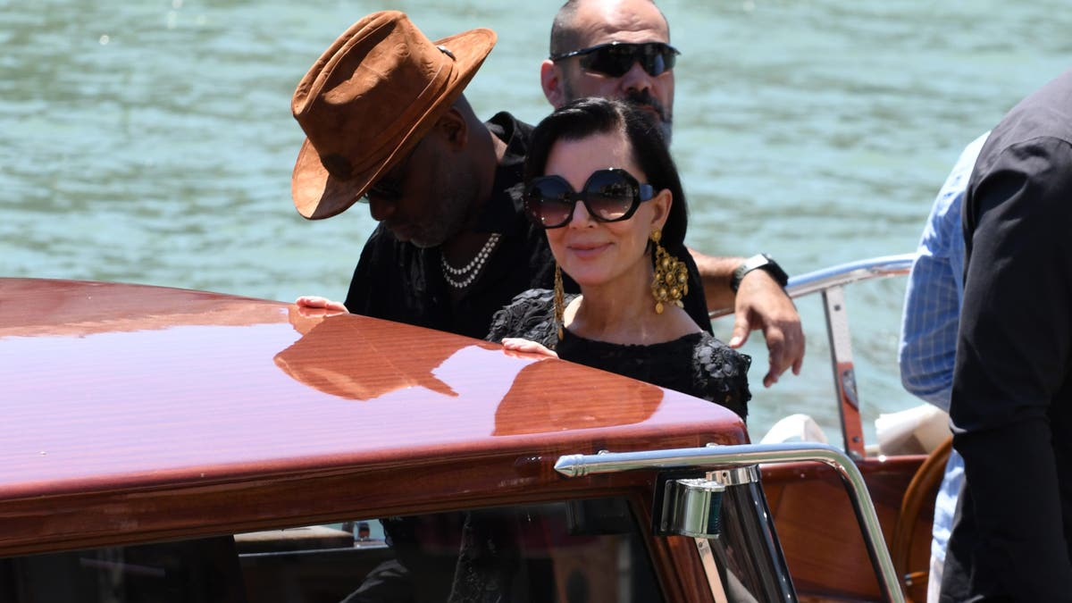 Kris Jenner smiles at camera while on a boat