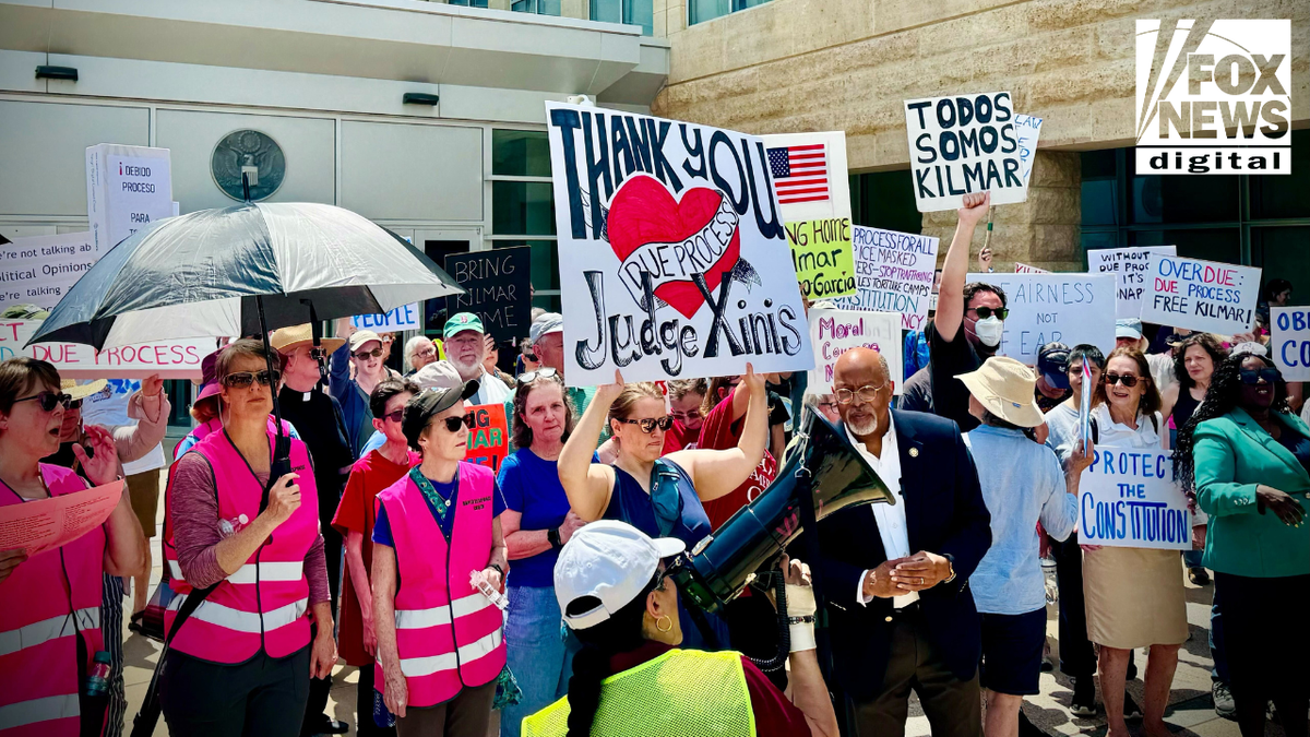 People pictured at a protest demanding Kilmar Abrego Garcia's return to the U.S.