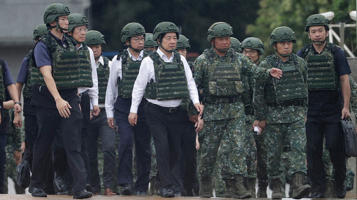 Taiwan President Lai Ching-te walking in military helmet and vest