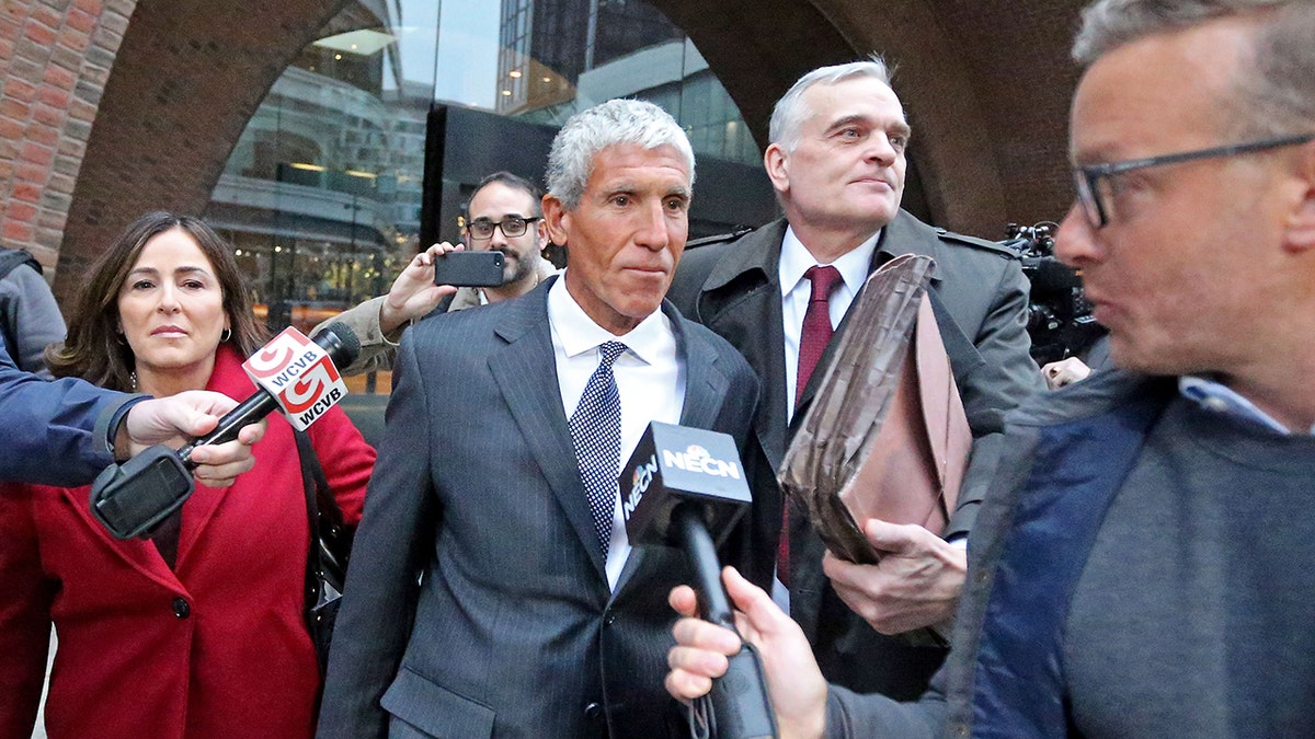 Robert Singer leaving court surrounded by reporters
