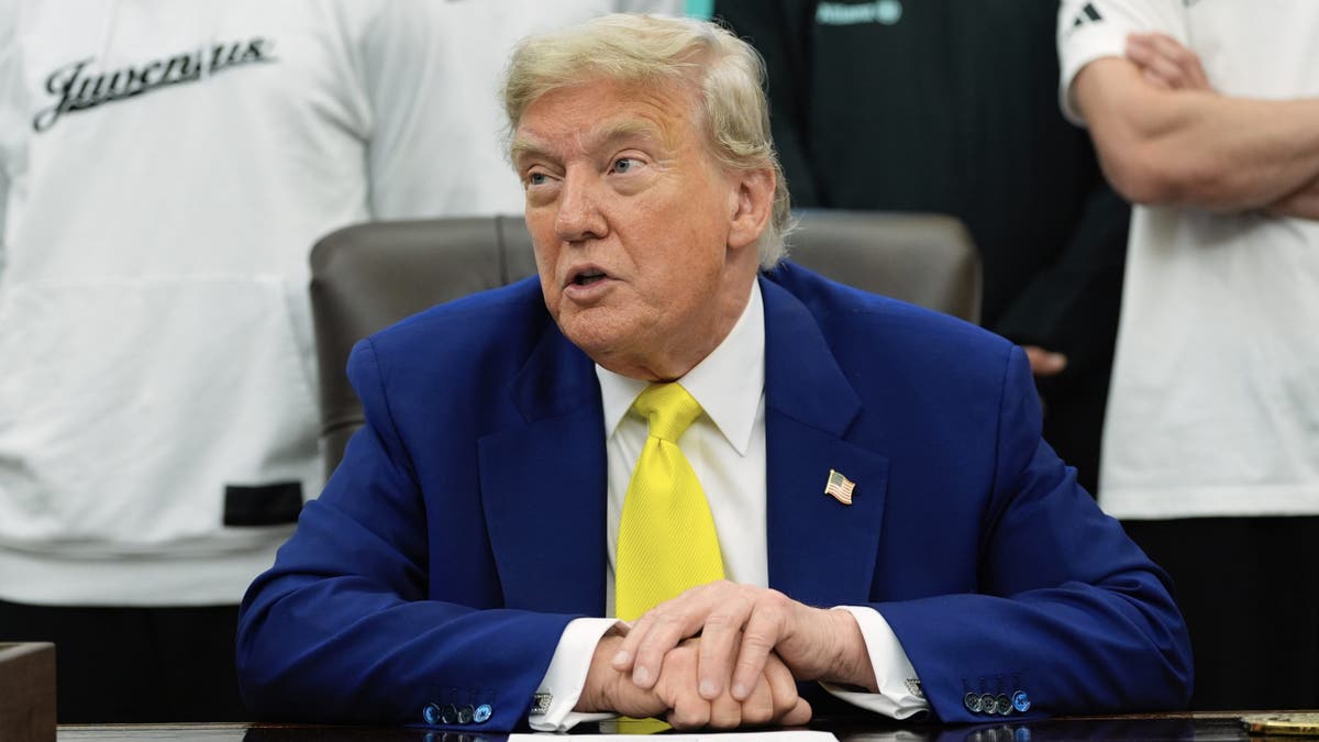 Trump sitting in oval office