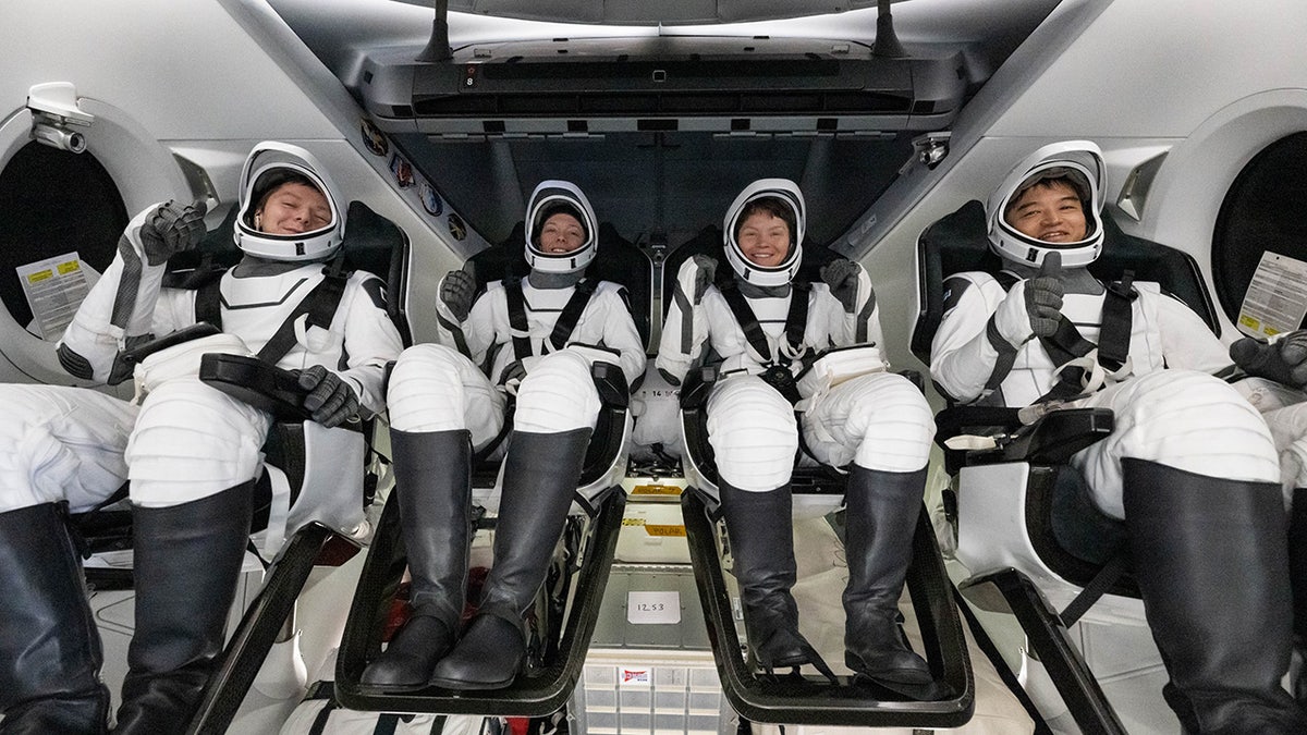 Crew members in capsule after splashdown