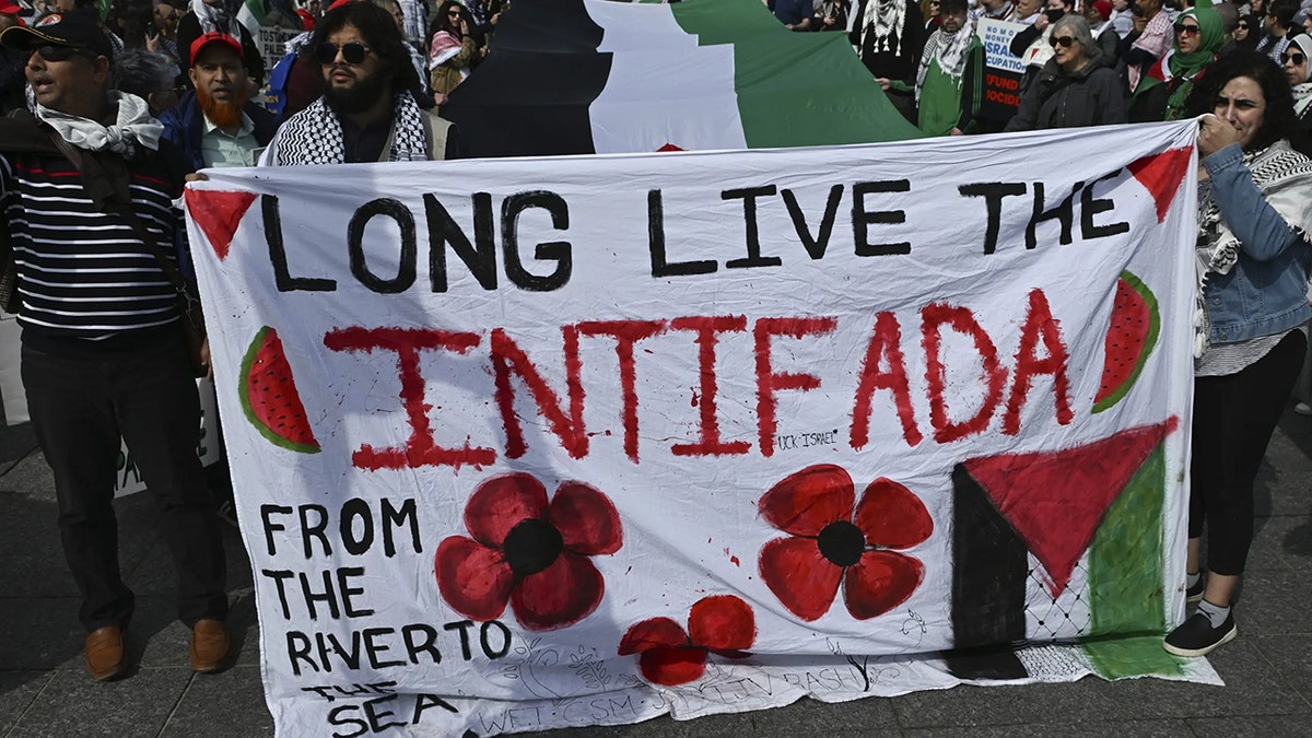 Anti-Israel protesters holding antisemitic posters in Alberta, Canada, on April 13, 2025.