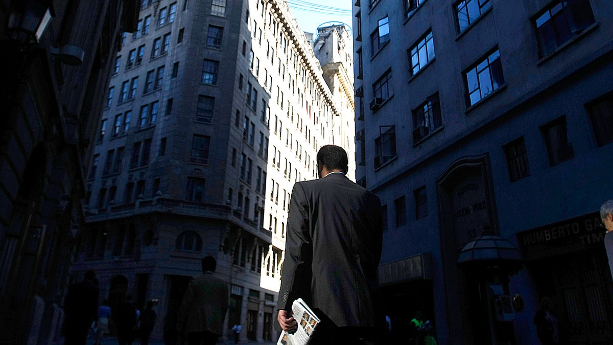 Men in suit walk through a financial district