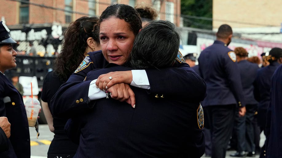 New York Police officers hug