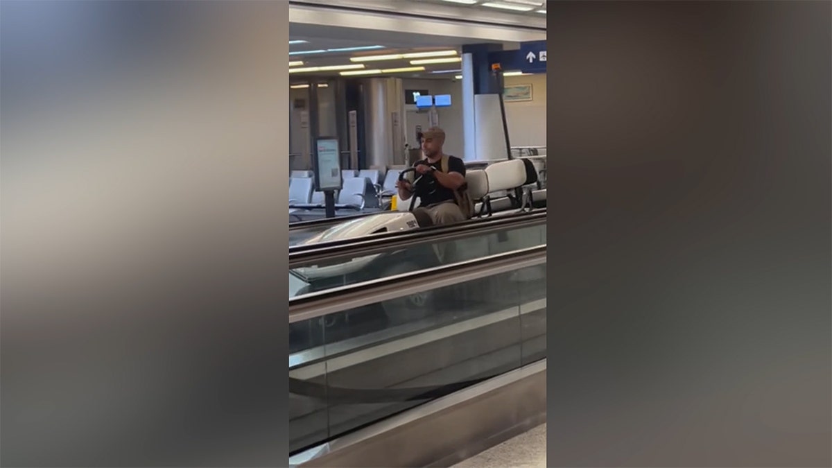 Man on airport golf cart