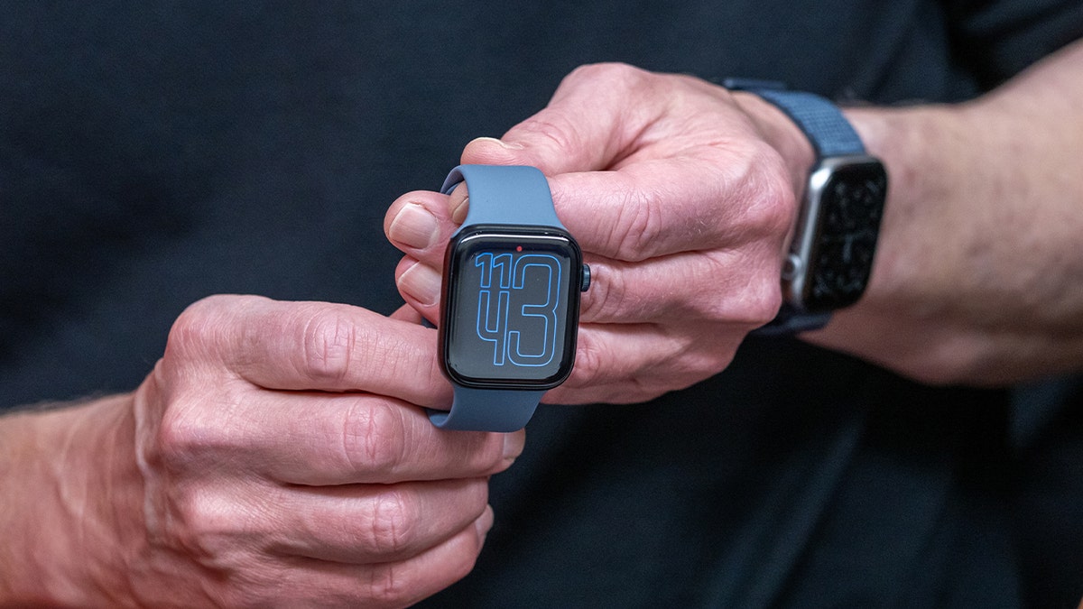 man holding apple watch series 11
