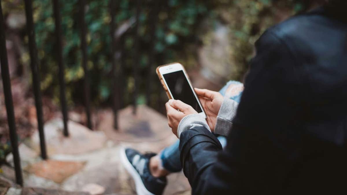 a person using apple phone outside