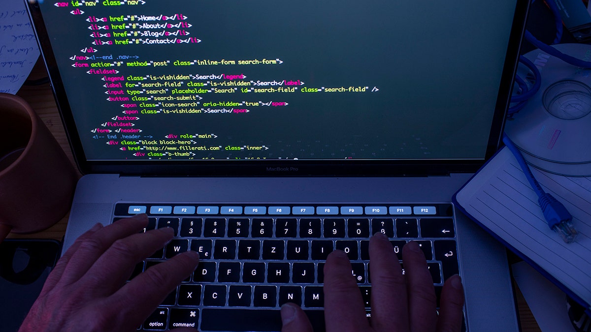 Hacker typing code.