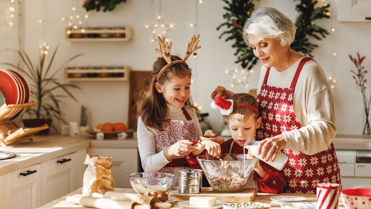 Elderly woman bakes holiday treat with children.