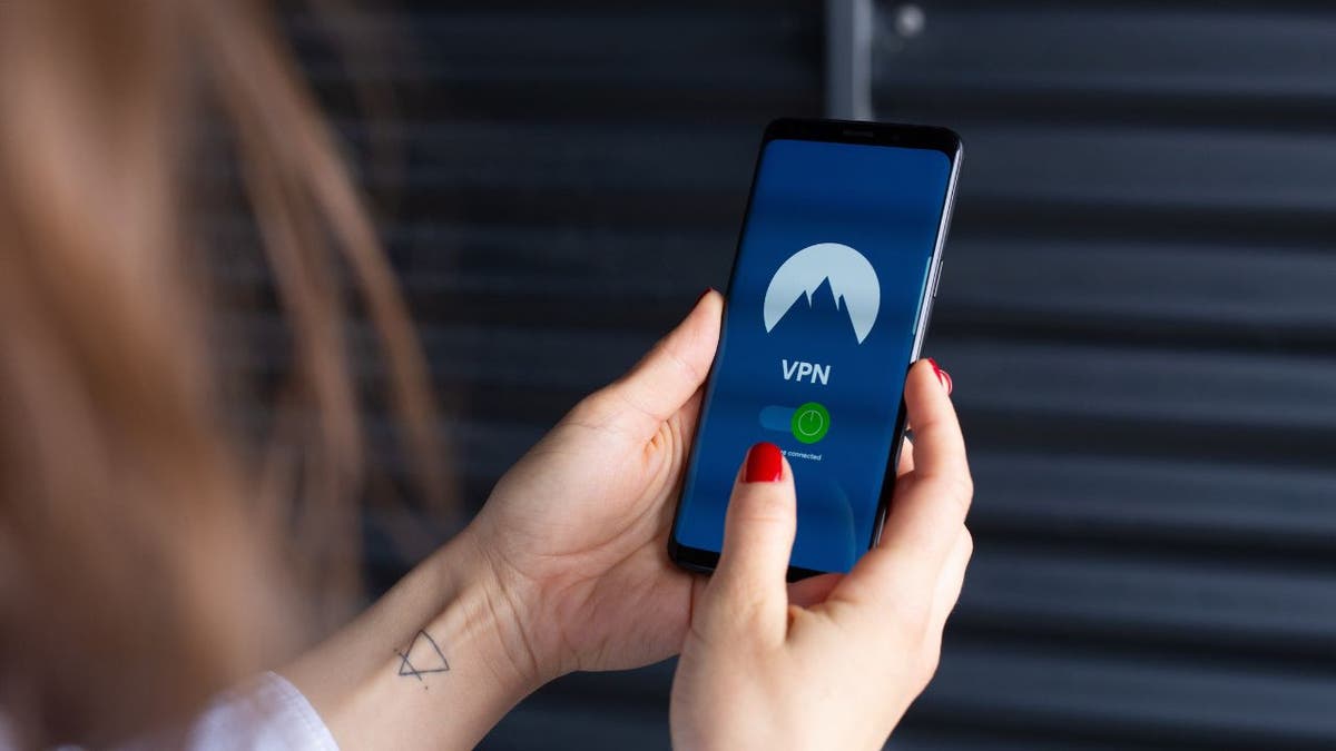 A woman looking at a VPN on a smartphone