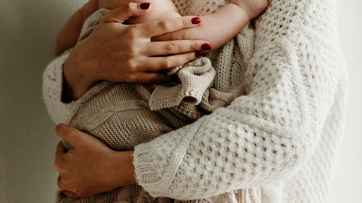 A mother holding a baby