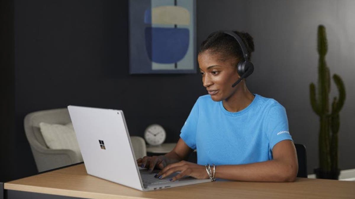 Woman typing on microsoft computer.