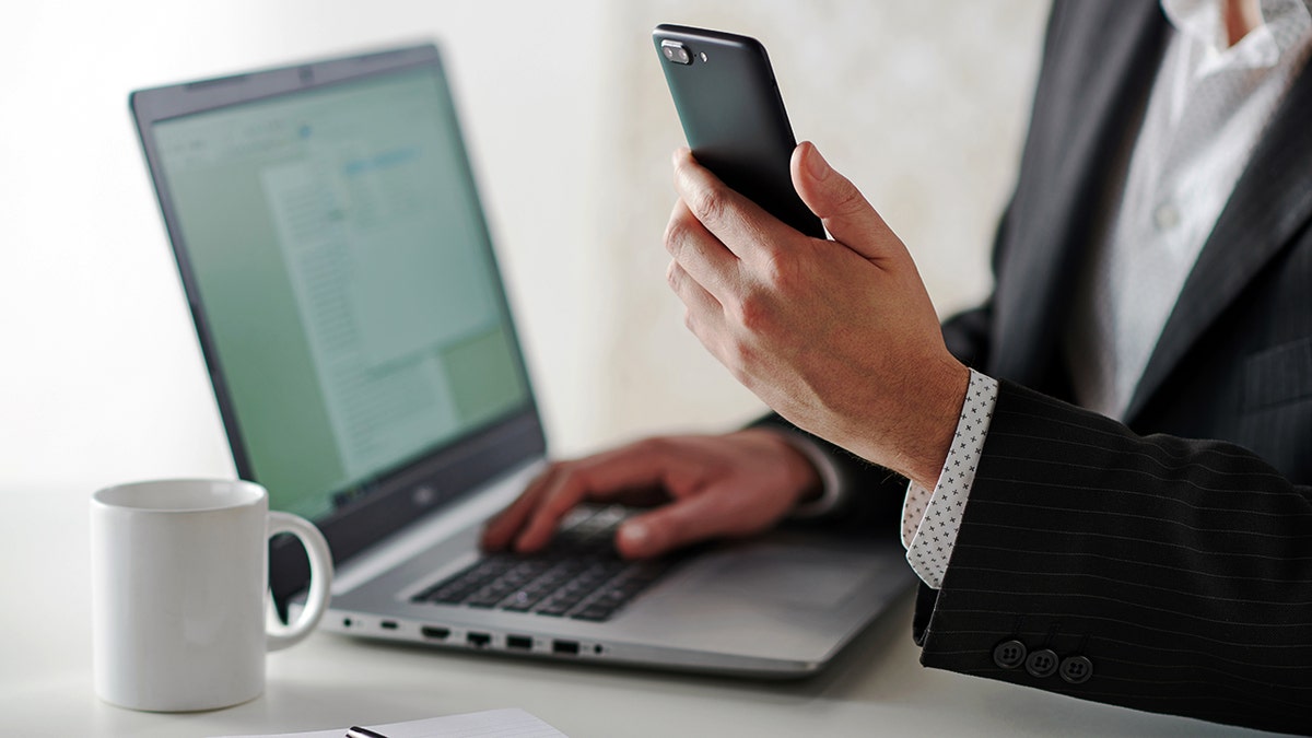 Person typing on their laptop.