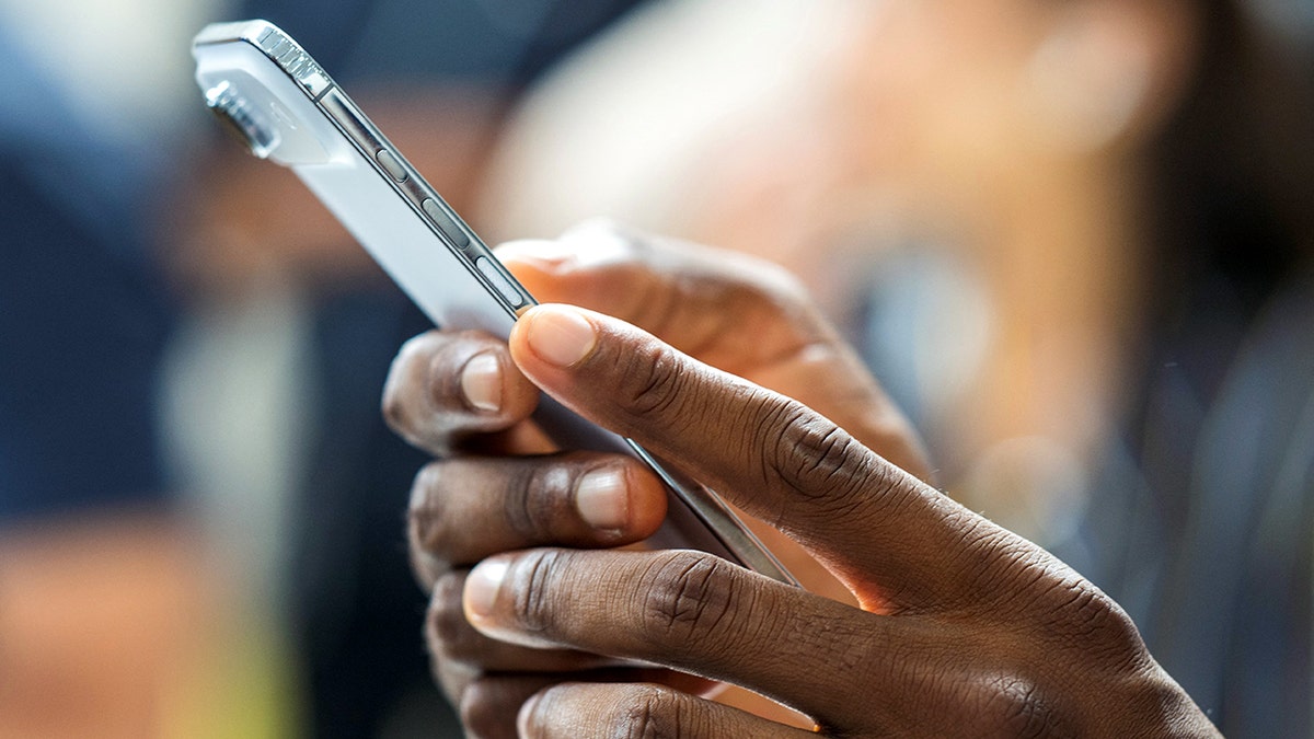 Person holding their phone.