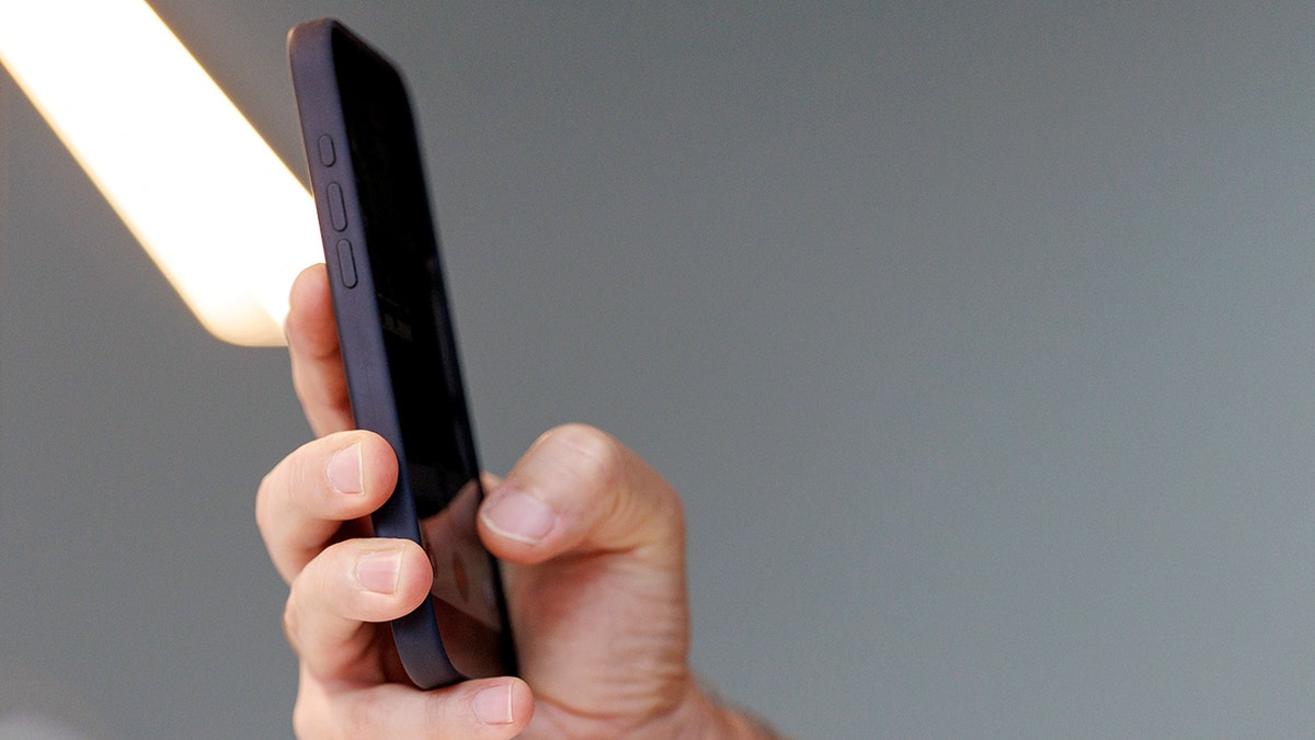 Man holding up his phone.