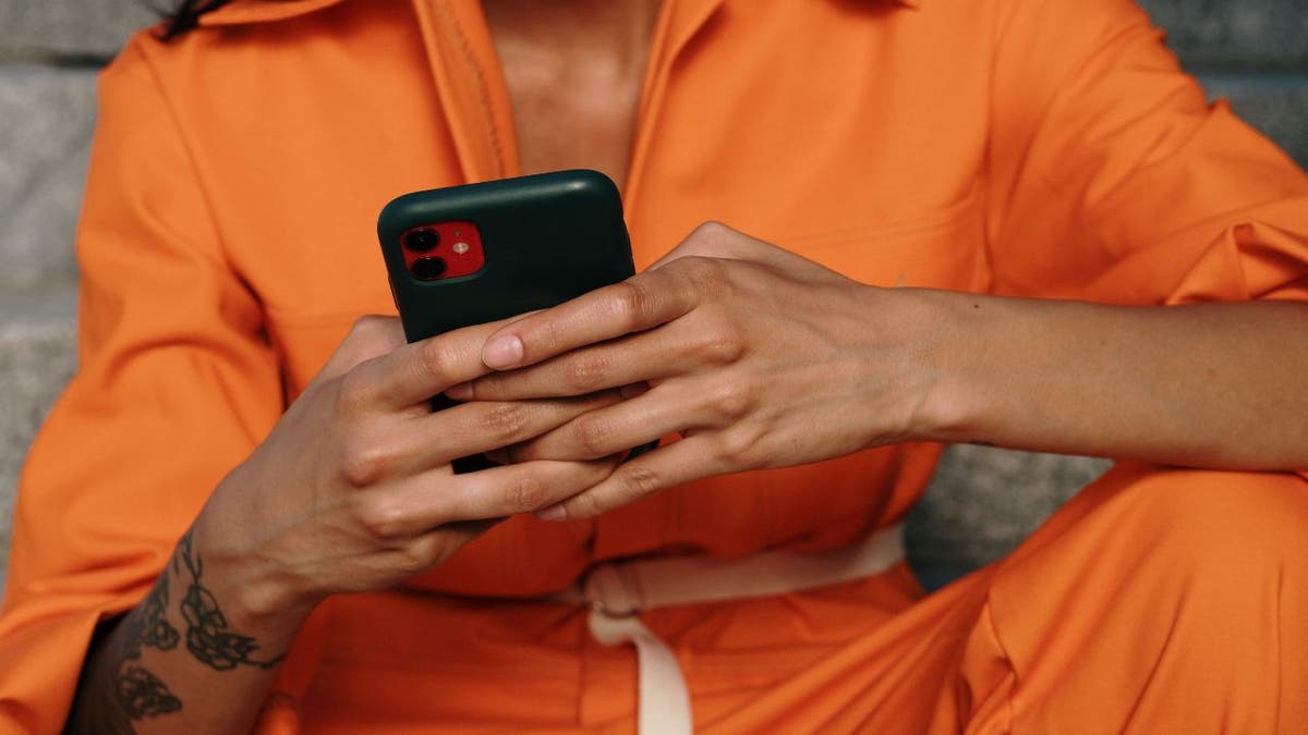 Person using their iPhone