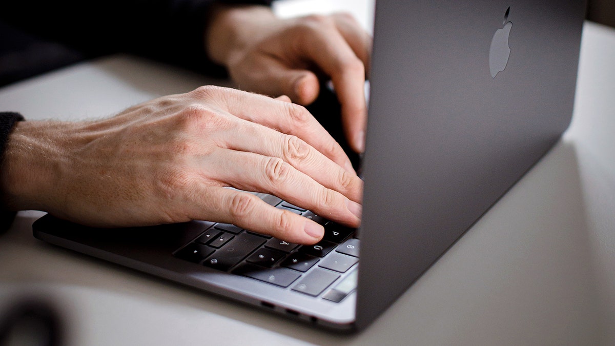 Person checking their emails on their laptop.