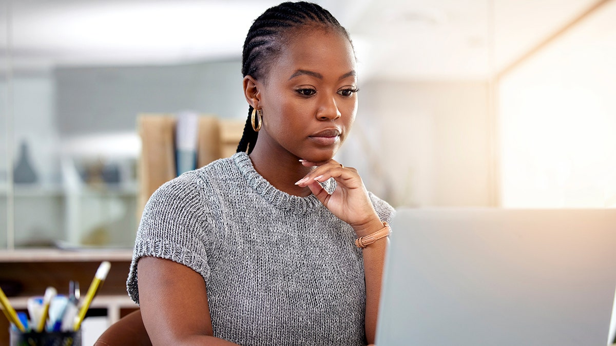 Woman works on laptop computer