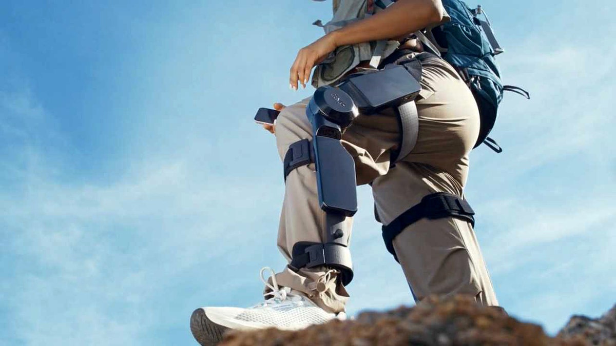 A person standing on a rock with an exoskeleton on his leg