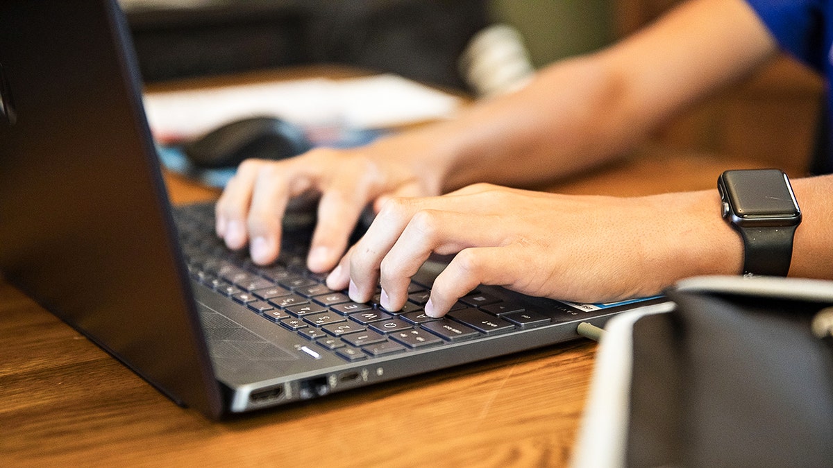 Teen using their laptop.