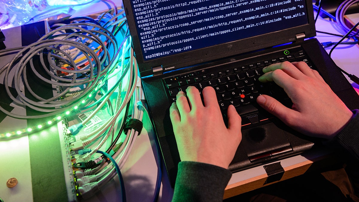 Hacker using a laptop.