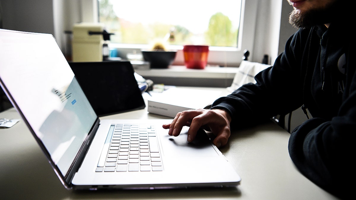 A man typing on his laptop.