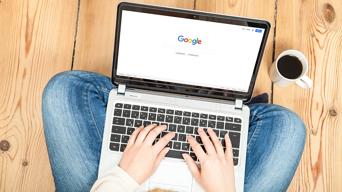 Woman sitting on the floor with her laptop.