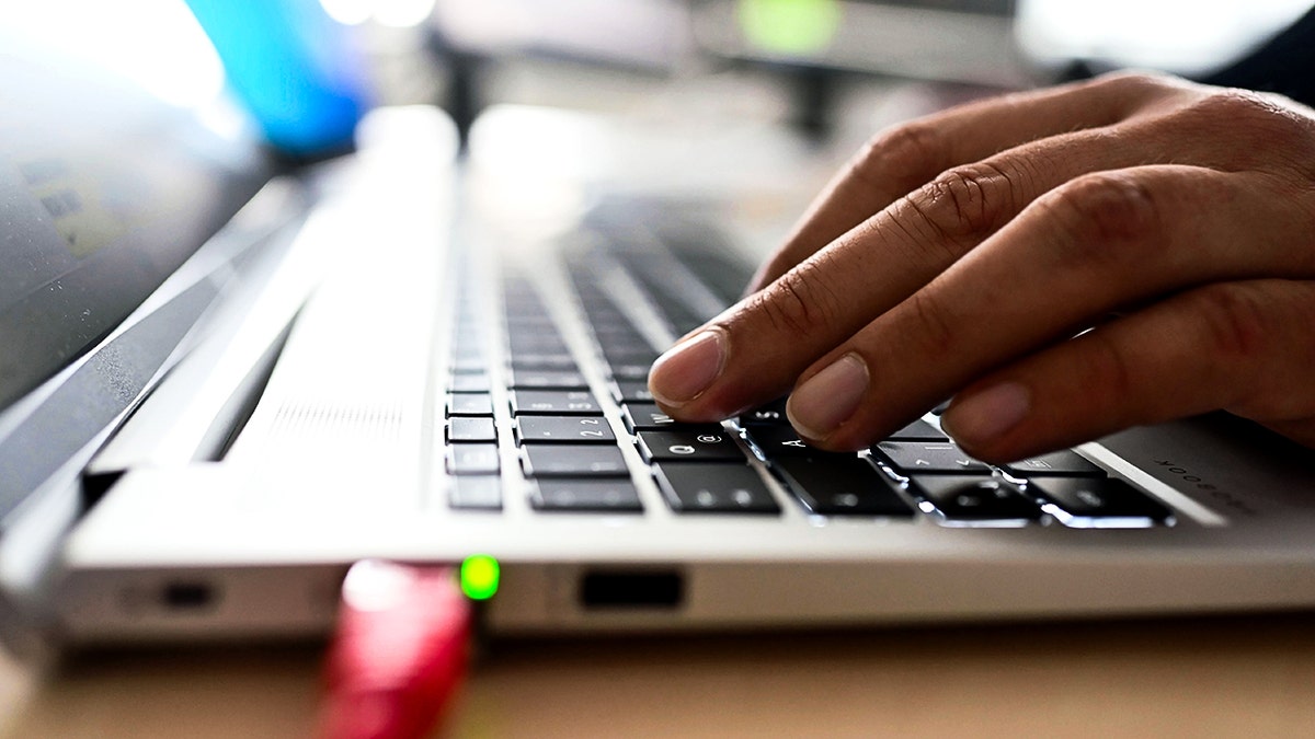 Person typing on a keyboard.