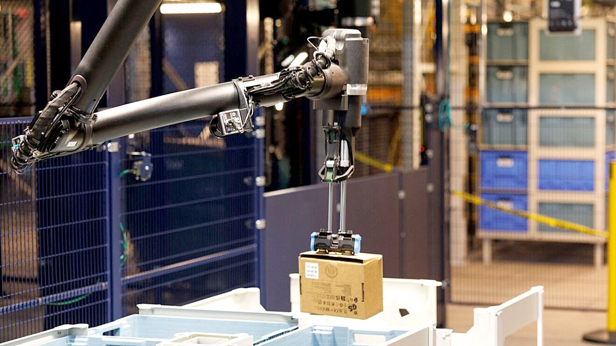 Amazon warehouse robot lifts a package