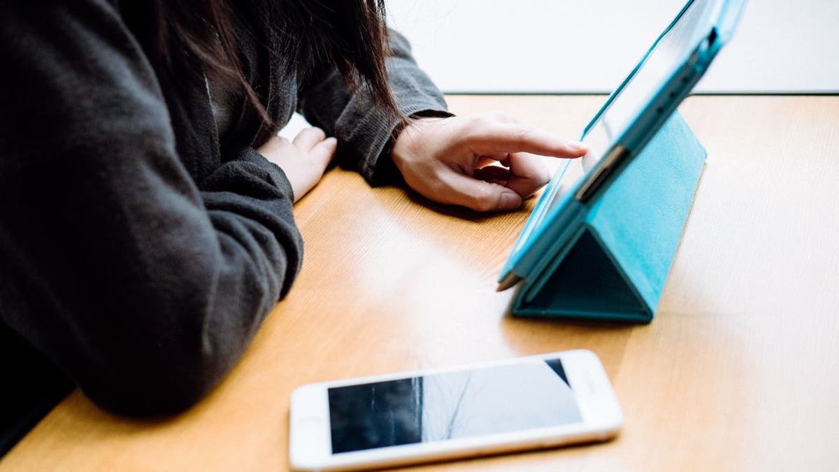 Woman looking through her iPad.