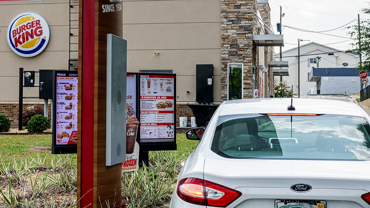 A customer orders at a Burger King drive-thru.